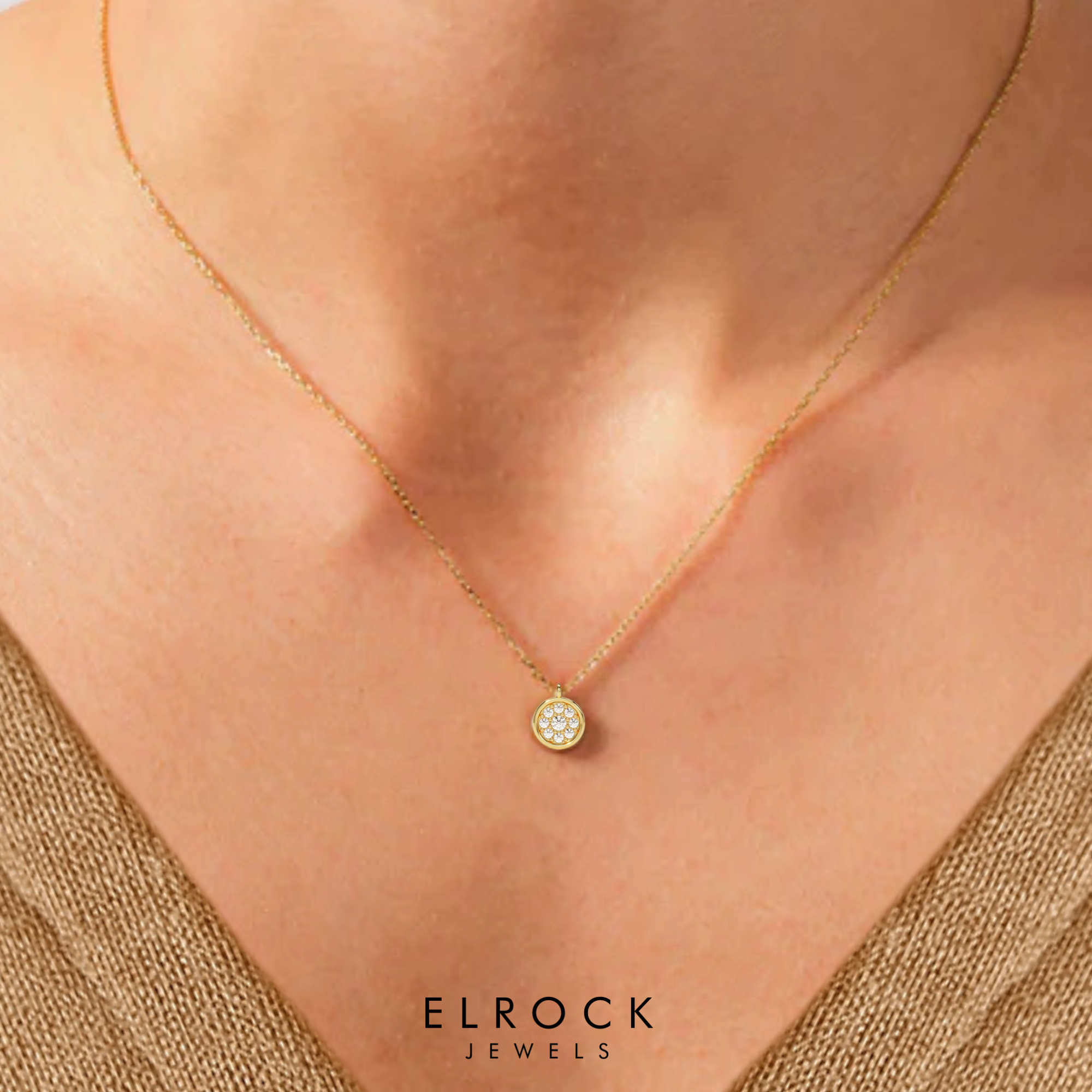 Gold necklace with a round pendant featuring crystals