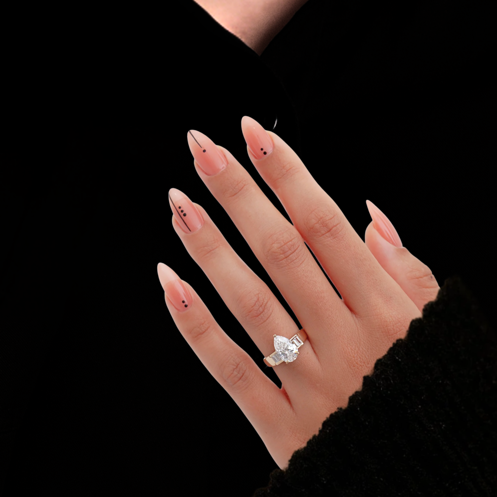 Gold ring with a pear-shaped diamond and baguette side stones
