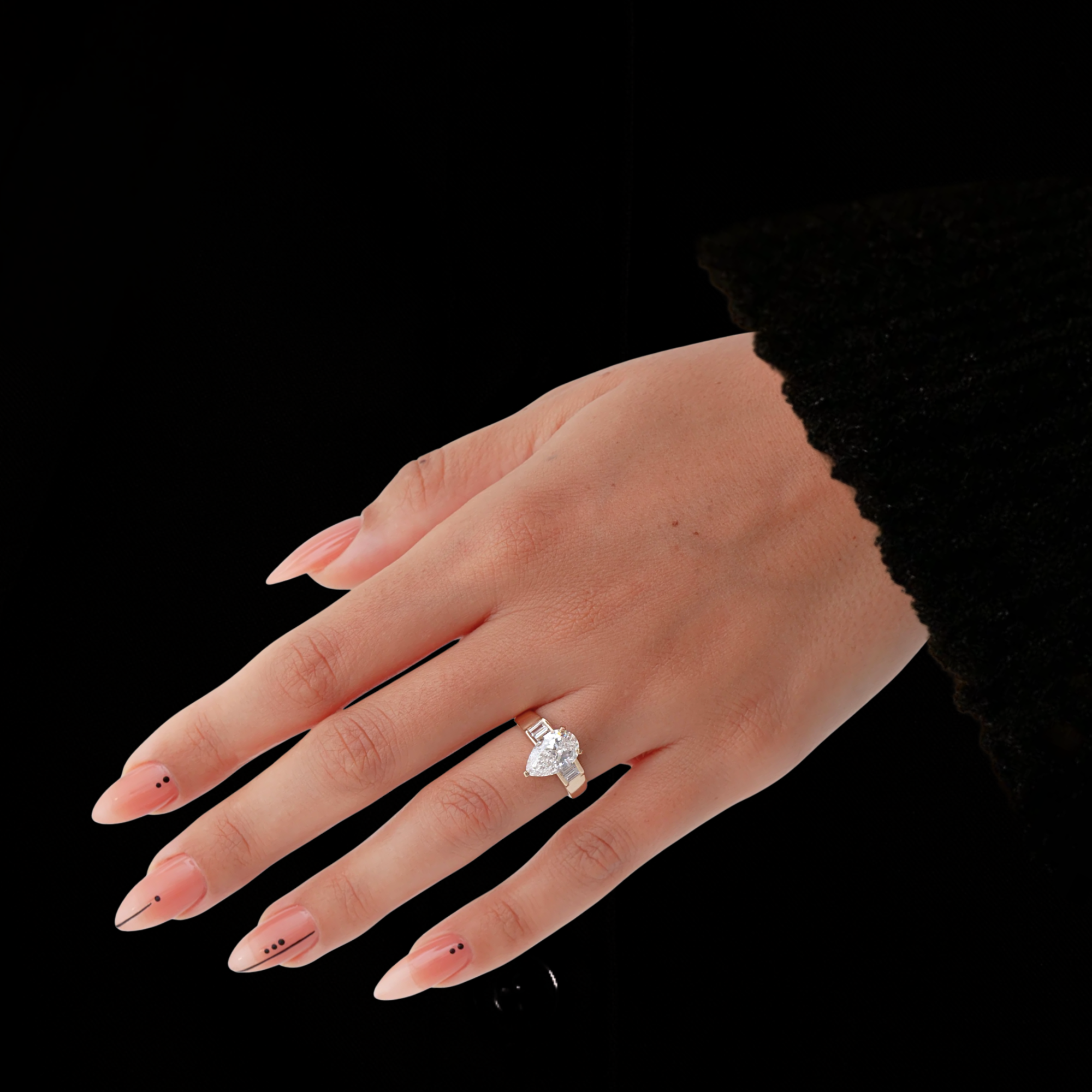 Gold ring with a pear-shaped diamond and baguette side stones