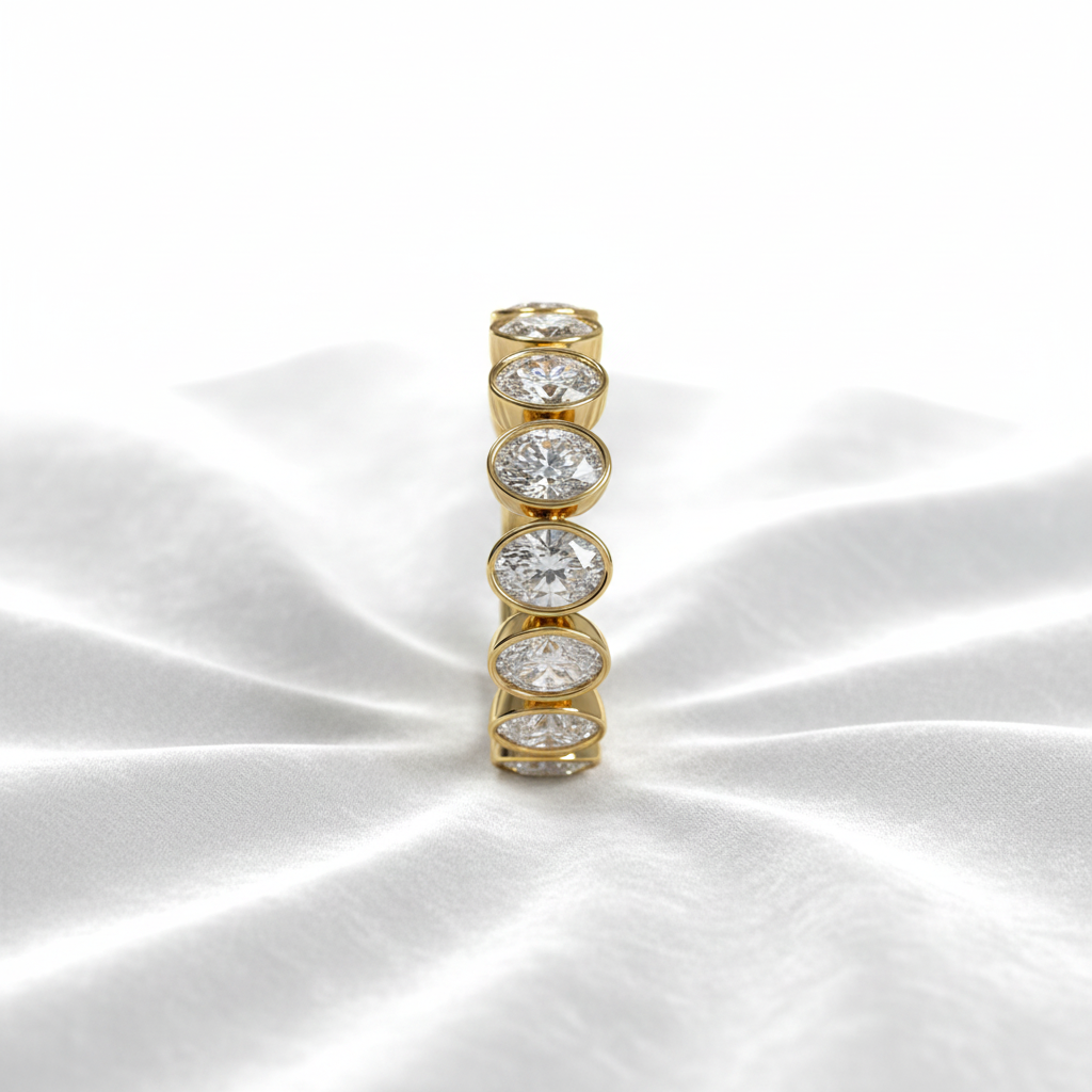 14K gold oval eternity lab grown diamond wedding band on wavy white velvet, studio lighting