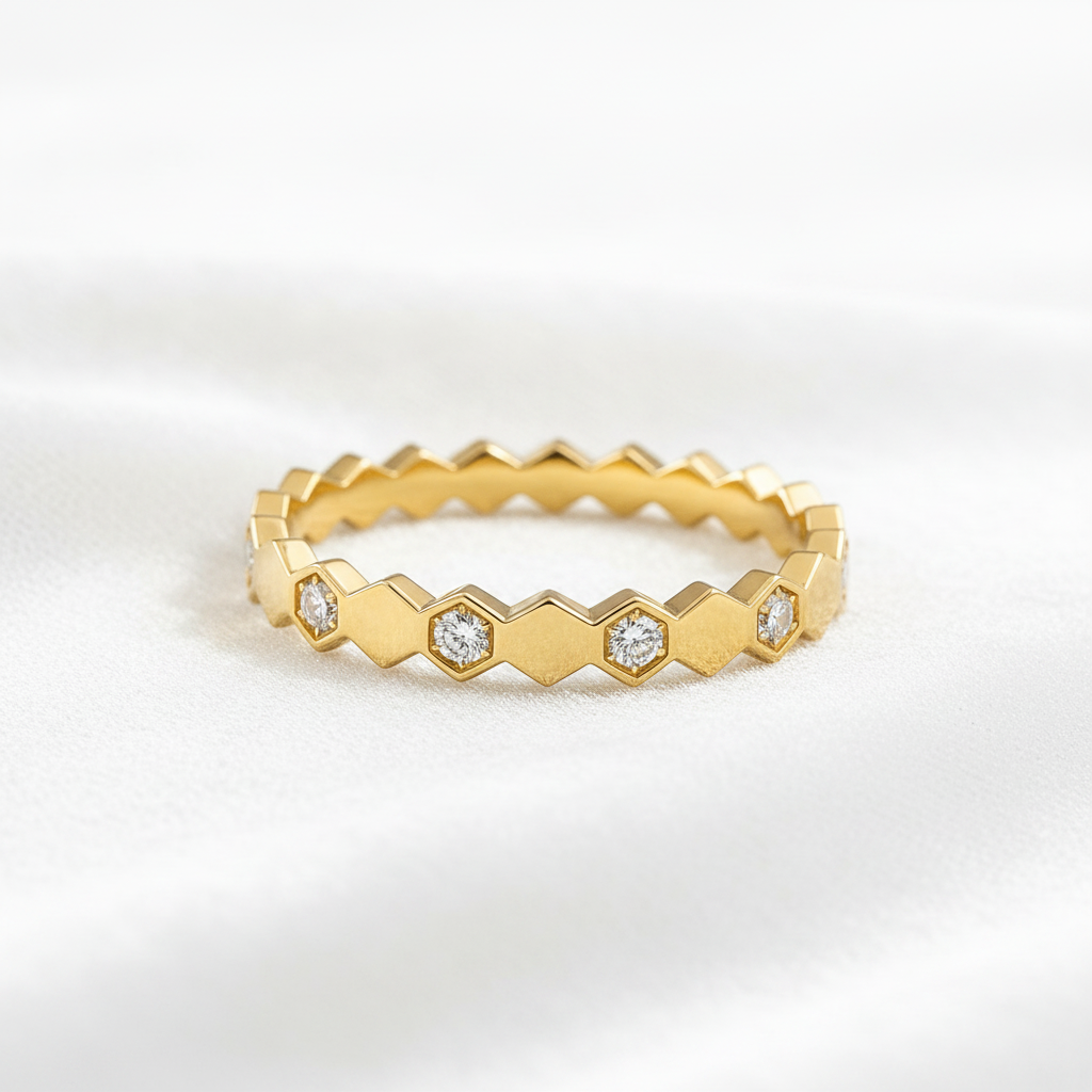 14K gold honeycomb hexagon pattern diamond wedding band on wavy white velvet, studio lighting