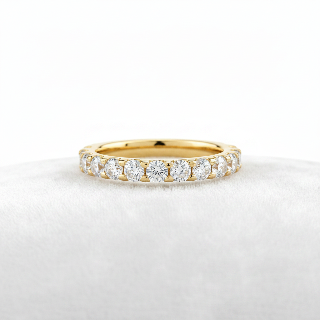 14K gold pavé half eternity diamond wedding band upright on white velvet, studio lighting macro shot