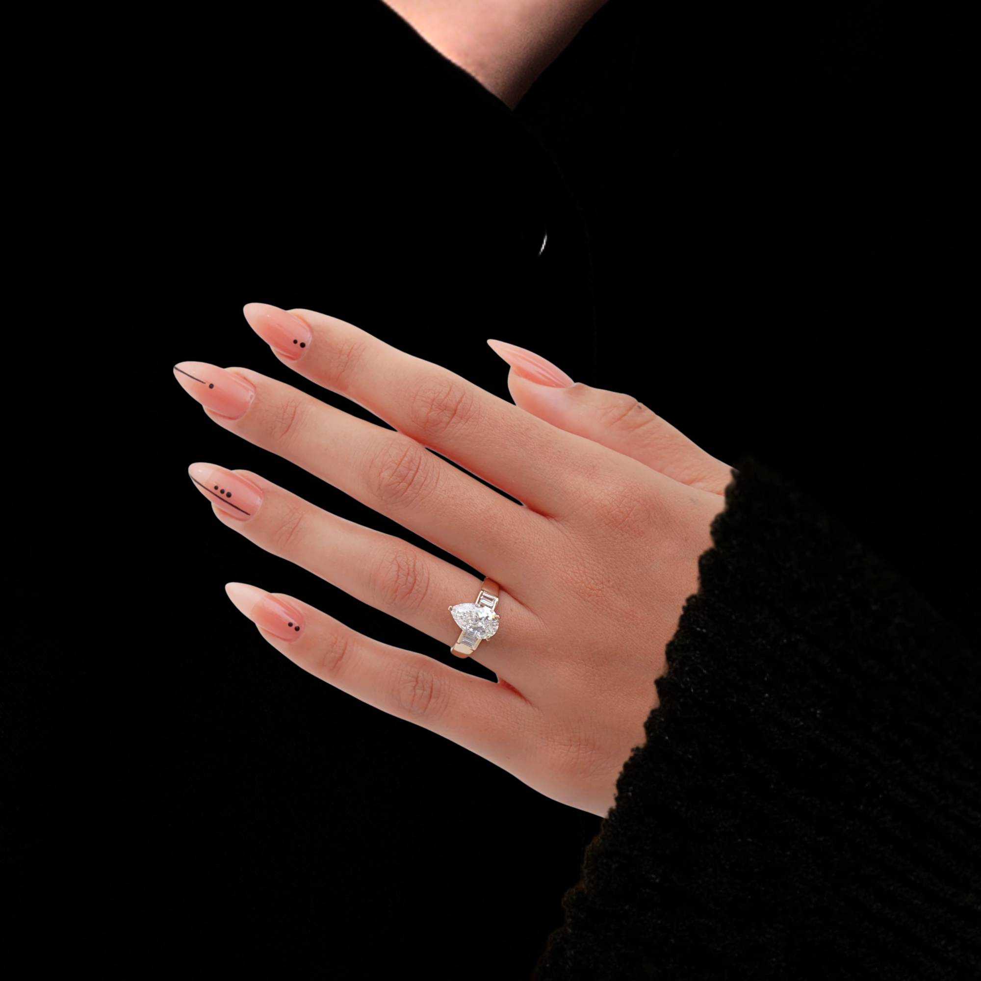 Gold ring with a pear-shaped diamond and baguette side stones 