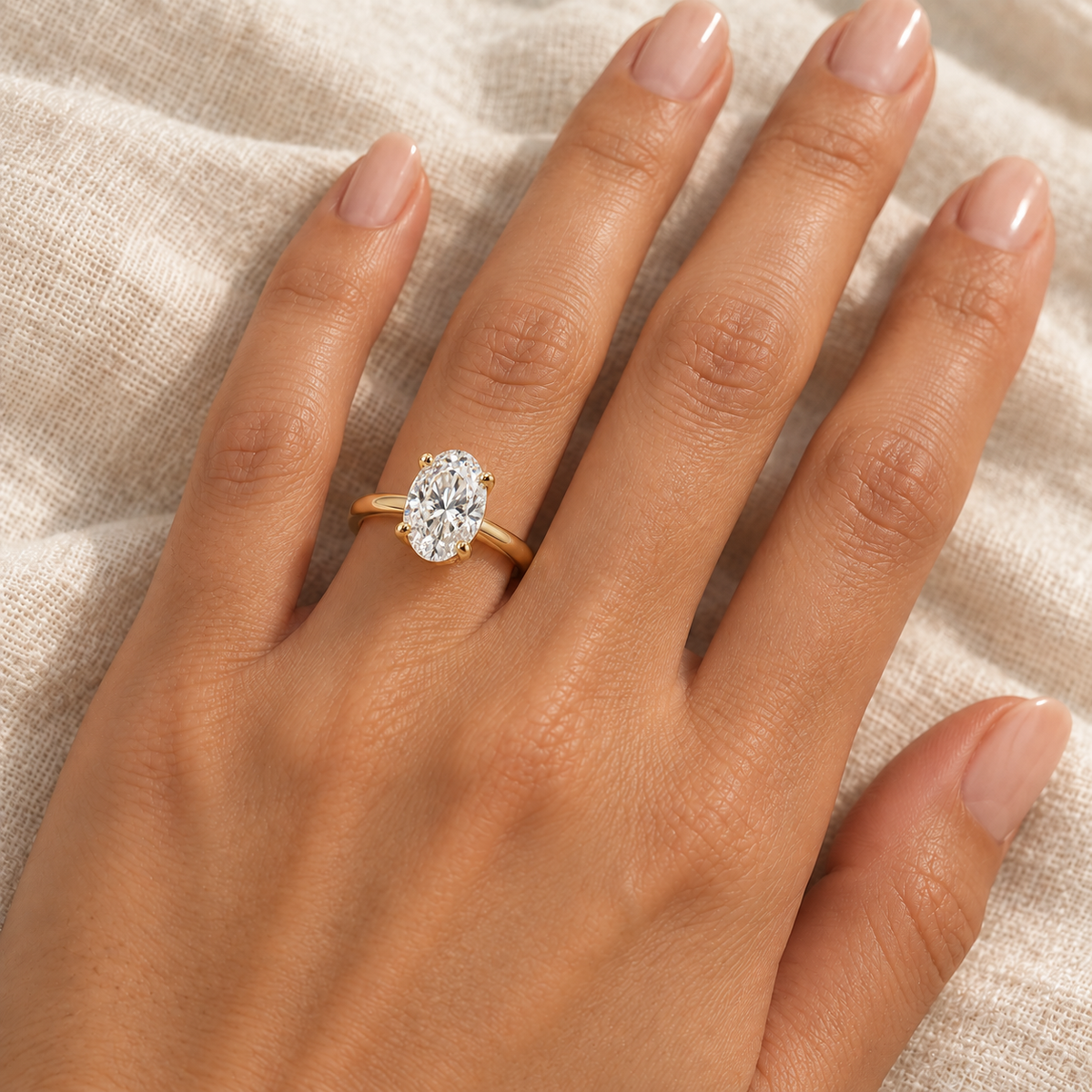 AI-generated close-up of the 2 ct oval yellow gold solitaire ring worn on an adult model's ring finger.