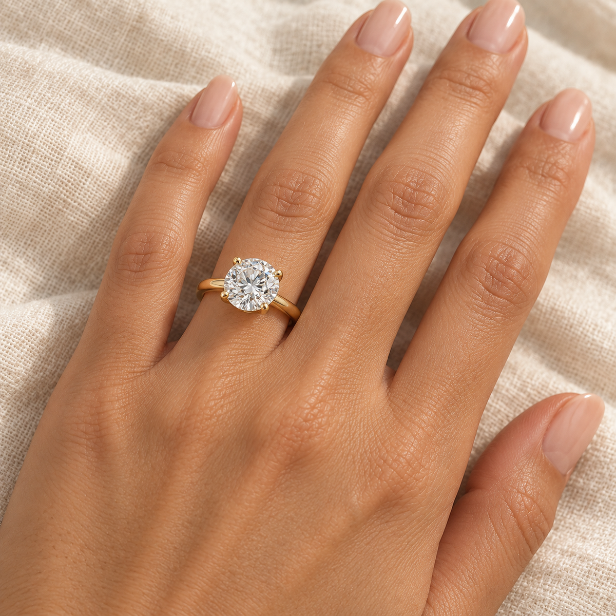 AI-generated close-up of the yellow gold solitaire ring worn on an adult model's ring finger.
