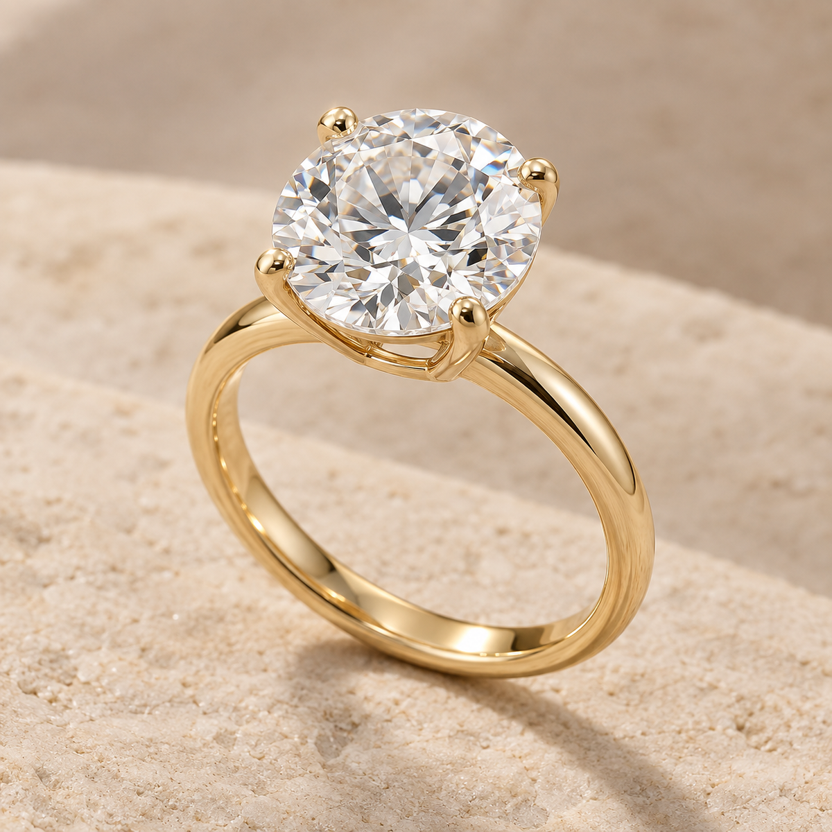 AI-generated preview of a 2 ct round lab-grown diamond solitaire ring in 14K yellow gold on an ivory stone surface.