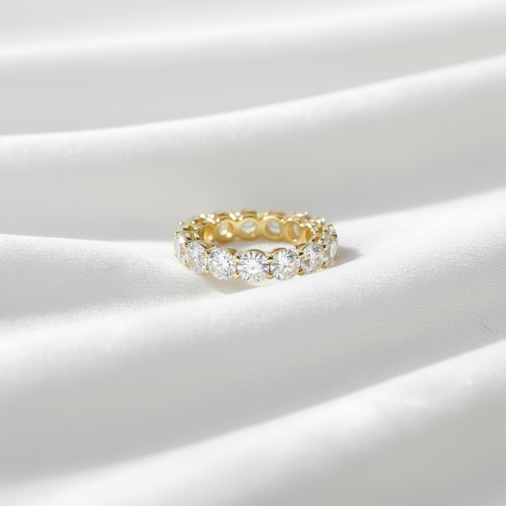14K gold U shape lab grown diamond eternity wedding band on wavy white velvet, studio lighting