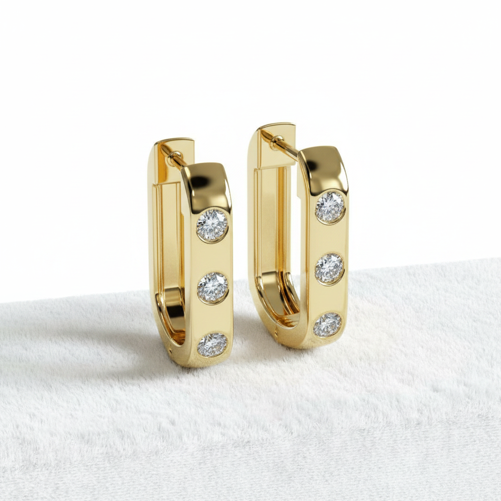 14K gold U-shape diamond huggie hoop earrings on white velvet, studio lighting