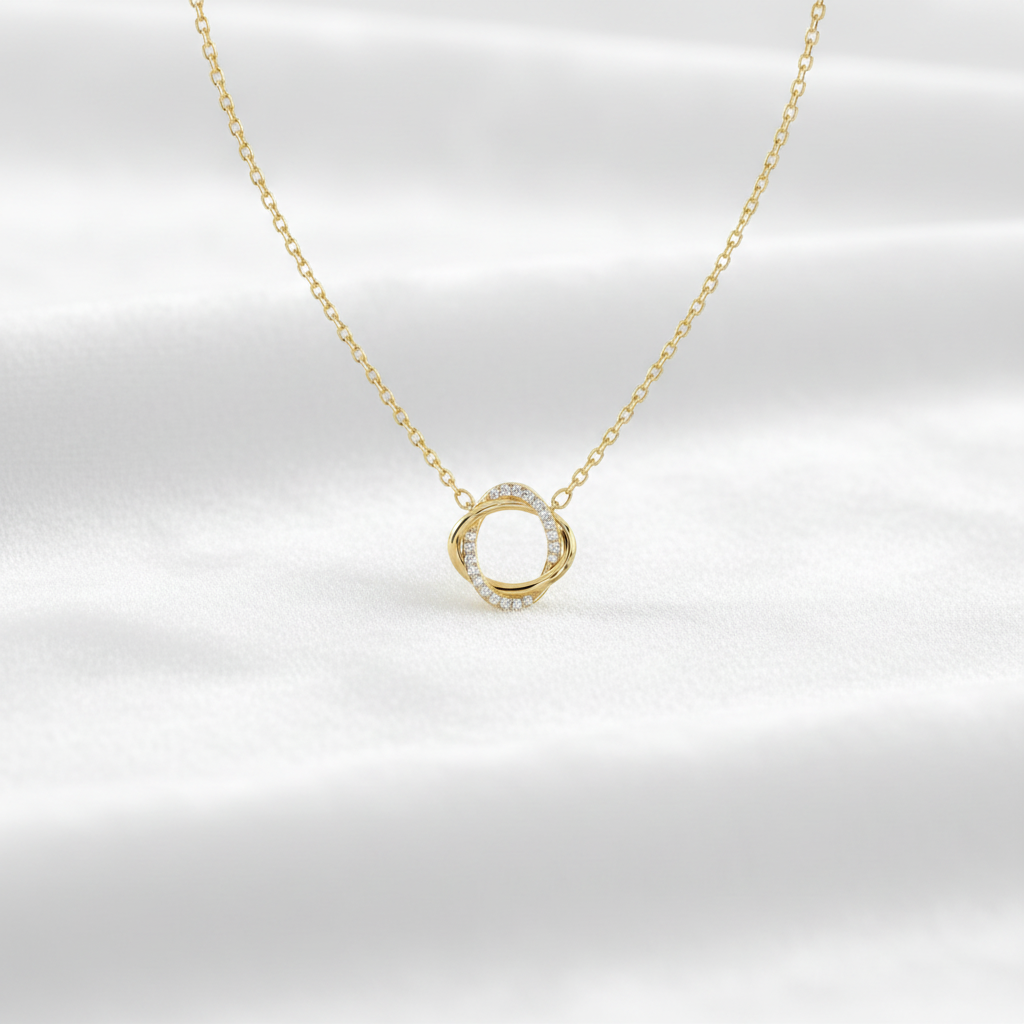 14K gold twisted circle diamond pendant necklace on wavy white velvet, studio lighting