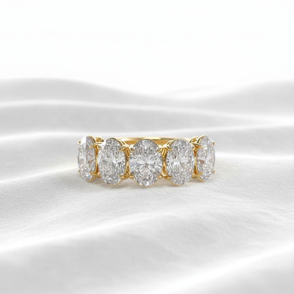 14K gold 2.09ct oval cut lab grown diamond wedding band on wavy white velvet, studio lighting