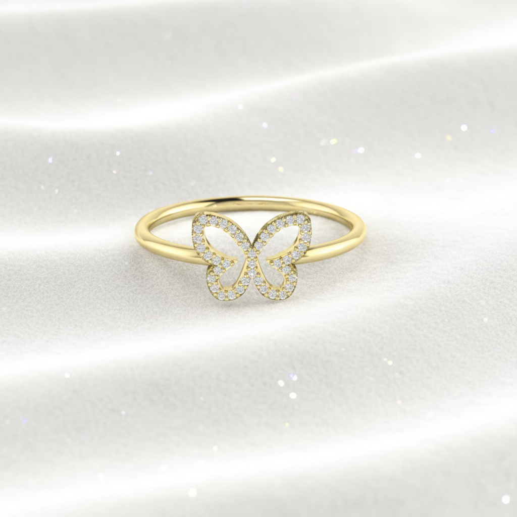 14K gold butterfly pavé diamond wedding ring on wavy white velvet, studio lighting