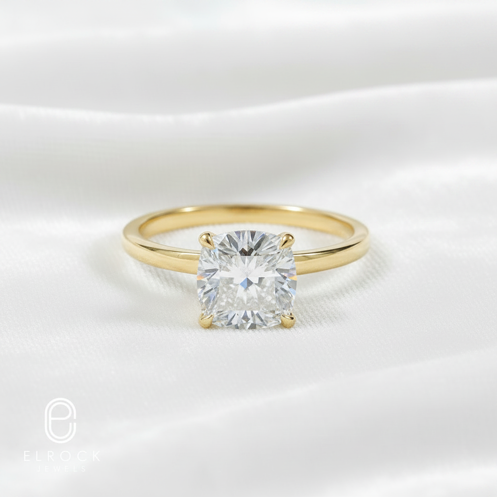 14K gold cushion cut lab diamond solitaire engagement ring on wavy white velvet, studio lighting